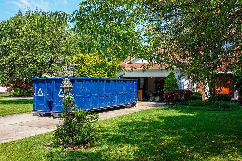 blue-dumpster-in-the-driveway
